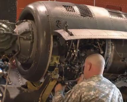 Soldier repairing a helicopter engine