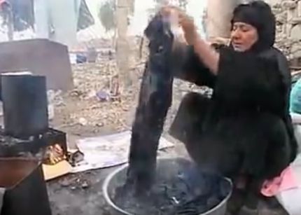 Woman washing clothes outside